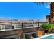 Beautiful Las Vegas city view from patio with black metal railing and landscaping around the pool area at 795 Glistening Light Ct, Henderson, NV 89052