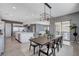 Bright dining room features modern lighting, a large table and an open floorplan at 795 Glistening Light Ct, Henderson, NV 89052