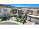 Stylish modern home with manicured landscaping, a two-car garage, and a stone facade at 795 Glistening Light Ct, Henderson, NV 89052