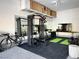 Garage features home gym equipment and wall mounted shelves for ample storage at 795 Glistening Light Ct, Henderson, NV 89052