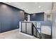 Bright hallway features a blue accent wall, recessed lighting and modern railings at 795 Glistening Light Ct, Henderson, NV 89052