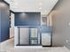 Well-lit hallway on the second floor with blue accent wall and modern railings at 795 Glistening Light Ct, Henderson, NV 89052