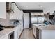Elegant kitchen featuring white cabinetry, stainless steel appliances, and quartz countertops at 795 Glistening Light Ct, Henderson, NV 89052