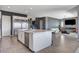 Open-concept kitchen boasts a large island with seating and stainless steel appliances at 795 Glistening Light Ct, Henderson, NV 89052