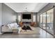 Stylish living room features a modern fireplace, large windows and comfortable seating at 795 Glistening Light Ct, Henderson, NV 89052