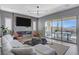Comfortable living room with a modern fireplace, TV, and sliding glass doors to outdoor patio at 795 Glistening Light Ct, Henderson, NV 89052