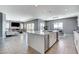 Open-concept living space with kitchen island, cozy fireplace, and tile flooring throughout at 795 Glistening Light Ct, Henderson, NV 89052