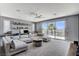 Spacious living room features a modern ceiling fan, plush seating, and access to a private balcony at 795 Glistening Light Ct, Henderson, NV 89052