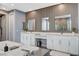 Luxurious primary bathroom showcasing dual vanities and glass-enclosed shower at 795 Glistening Light Ct, Henderson, NV 89052