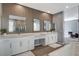 Beautiful primary bathroom with wood accent wall and dual sink vanity at 795 Glistening Light Ct, Henderson, NV 89052