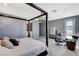 A view of the main bedroom featuring a four-poster bed and an adjoining bathroom at 795 Glistening Light Ct, Henderson, NV 89052