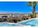 The pool offers a serene escape with benches and stunning city views in the background at 795 Glistening Light Ct, Henderson, NV 89052
