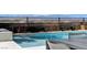 Sparkling pool with patio seating provides a tranquil escape with scenic mountain views at 795 Glistening Light Ct, Henderson, NV 89052