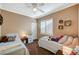 Cozy bedroom with two twin beds, ceiling fan, and plantation shutters at 8129 Jim Steele Falls St, North Las Vegas, NV 89085