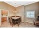 Charming dining area with bench seating, chandelier, and natural light at 8129 Jim Steele Falls St, North Las Vegas, NV 89085