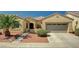 Charming single-story home with desert landscaping, steps up to the front door and two-car garage at 8129 Jim Steele Falls St, North Las Vegas, NV 89085