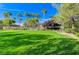 Community greenspace with palm trees and manicured landscaping on a bright, sunny day at 8129 Jim Steele Falls St, North Las Vegas, NV 89085