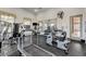 Onsite gym/workout room featuring modern equipment, a wall-mounted television and rubber flooring at 8129 Jim Steele Falls St, North Las Vegas, NV 89085