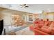 Open-concept living and dining area featuring tile floors and a coral-colored sofa at 8129 Jim Steele Falls St, North Las Vegas, NV 89085
