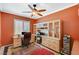 Home office with built-in shelves, ceiling fan and a view of the front yard at 8129 Jim Steele Falls St, North Las Vegas, NV 89085
