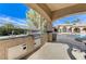 Outdoor stainless steel grill and sink with granite countertop under a shaded patio at 8129 Jim Steele Falls St, North Las Vegas, NV 89085