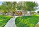 Community playground featuring a covered play structure, mature shade trees, and landscaped surroundings at 8129 Jim Steele Falls St, North Las Vegas, NV 89085