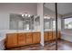 Bathroom with a double sink vanity, large mirror, separate shower and soaking tub at 1036 Kennebunk Cir, Henderson, NV 89015