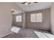 Bright bedroom featuring gray carpet, a ceiling fan, and two windows at 1036 Kennebunk Cir, Henderson, NV 89015