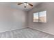 Bedroom featuring gray carpet, neutral walls, a window, and ceiling fan at 1036 Kennebunk Cir, Henderson, NV 89015
