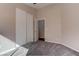 Neutral bedroom featuring gray carpet, ensuite bathroom, and closet with sliding doors at 1036 Kennebunk Cir, Henderson, NV 89015