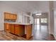 Spacious kitchen with center island, wood cabinets, modern countertops, and wood-look flooring at 1036 Kennebunk Cir, Henderson, NV 89015