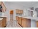 Bright kitchen boasts wood cabinets, modern countertops, stylish backsplash, and wood-look flooring at 1036 Kennebunk Cir, Henderson, NV 89015