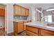 Bright kitchen features wood cabinets, modern countertops, stylish backsplash, and new flooring at 1036 Kennebunk Cir, Henderson, NV 89015