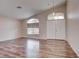 Bright living room features wood floors, large windows and double door entryway at 1036 Kennebunk Cir, Henderson, NV 89015