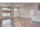 Bright living room features wood floors, large windows and double door entryway at 1036 Kennebunk Cir, Henderson, NV 89015