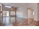 Bright living room with plank floors, neutral walls, fireplace and access to rear yard through sliding door at 1036 Kennebunk Cir, Henderson, NV 89015