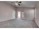 Bright main bedroom featuring a ceiling fan, neutral tones, and direct access to the backyard at 1036 Kennebunk Cir, Henderson, NV 89015