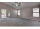 Bright main bedroom featuring neutral tones, a ceiling fan, and sliding glass door to the backyard at 1036 Kennebunk Cir, Henderson, NV 89015