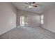 Comfortable main bedroom featuring a ceiling fan, neutral tones, and direct access to the backyard at 1036 Kennebunk Cir, Henderson, NV 89015