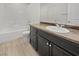 Well-lit bathroom with a vanity, and tub-shower combination with glass door at 10537 Headwind Ave, Las Vegas, NV 89129