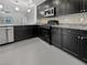 Contemporary kitchen with granite countertops, modern appliances, and dark cabinetry at 10537 Headwind Ave, Las Vegas, NV 89129
