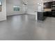 Open-concept living space with kitchen featuring dark cabinets and sleek appliances at 10537 Headwind Ave, Las Vegas, NV 89129