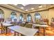 Bright art room equipped with tables, chairs, easels, and ample natural light for creative pursuits at 10580 Riva Grande Ct, Las Vegas, NV 89135