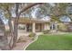 Charming backyard featuring lush landscaping and a covered patio area at 10580 Riva Grande Ct, Las Vegas, NV 89135