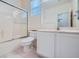 Bright bathroom features a shower-tub combo, sink vanity, and tile floors at 10580 Riva Grande Ct, Las Vegas, NV 89135