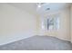 Spacious bedroom with carpet flooring and large windows providing ample natural light at 10580 Riva Grande Ct, Las Vegas, NV 89135