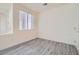 This bedroom features gray wood flooring, a window, and neutral walls at 10580 Riva Grande Ct, Las Vegas, NV 89135