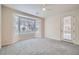 Bright, carpeted bedroom with a large bay window and a door to the outside at 10580 Riva Grande Ct, Las Vegas, NV 89135