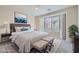 Serene bedroom with a large bay window, plush bedding, and stylish decor at 10580 Riva Grande Ct, Las Vegas, NV 89135