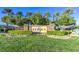 The community's entrance features lush landscaping and a stone sign, creating a welcoming atmosphere at 10580 Riva Grande Ct, Las Vegas, NV 89135